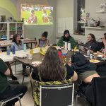 OPIRG team and community members sitting in a circle at tables in the Willow Arts Community studio.